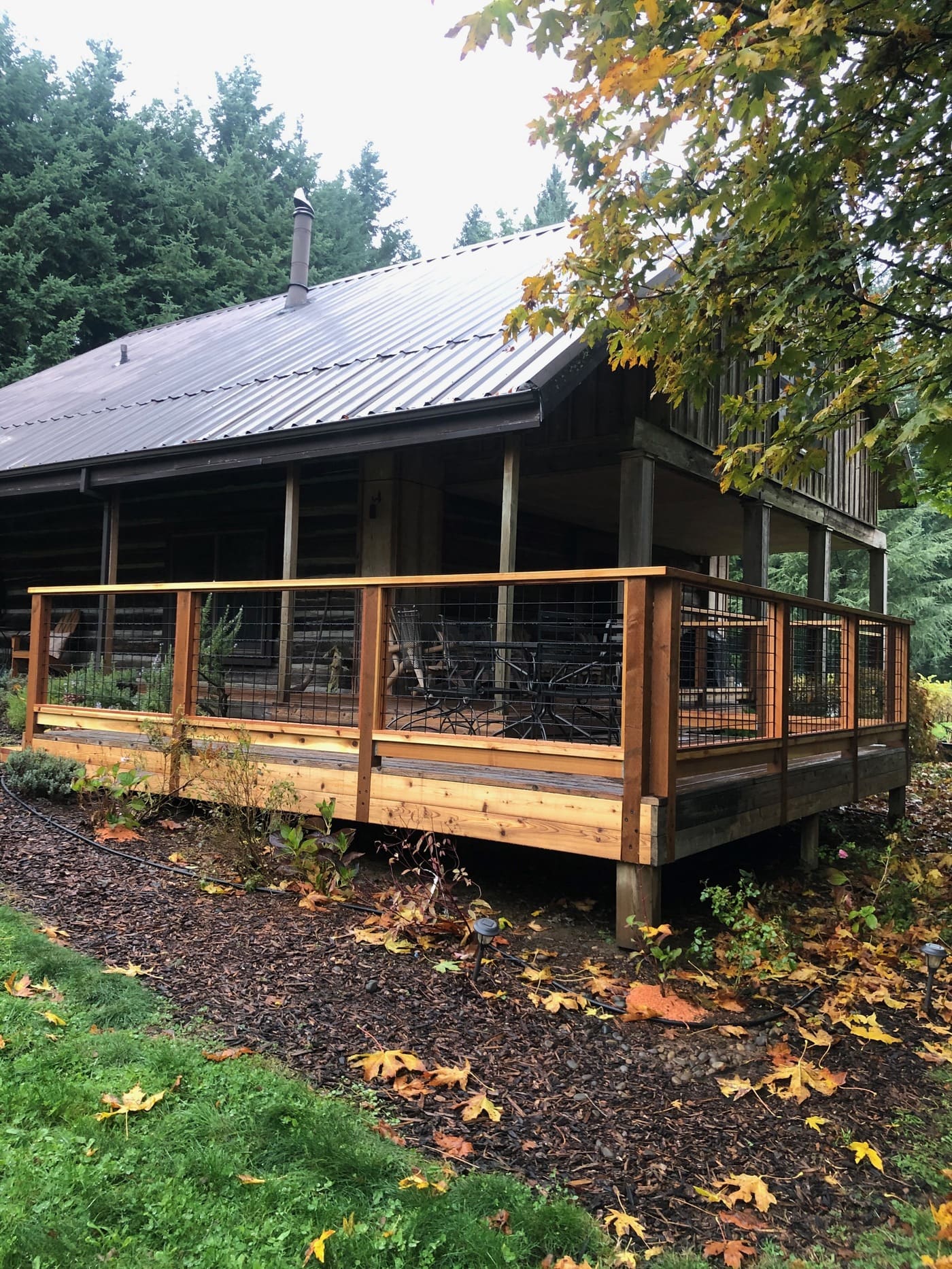 Cedar deck with hog-wire railing on rural building
